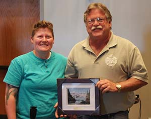 Blake Johnson receives a 20 year volunteer appreciation award from board president Amanda Bauer.