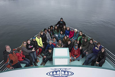 Lisa Matlock, center, poses with the Seward High School students and teachers in the bow of the Glacier Explorer.