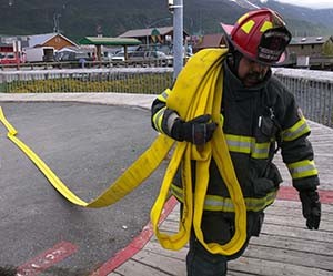 Firefighters participate in a simulated vessel fire exercise during the 2015 Marine Firefighting Symposium at the Valdez harbor. Photo by Zac Schasteen.