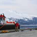 Image shows crew members standing on deck of Allison Creek waving at the camera.